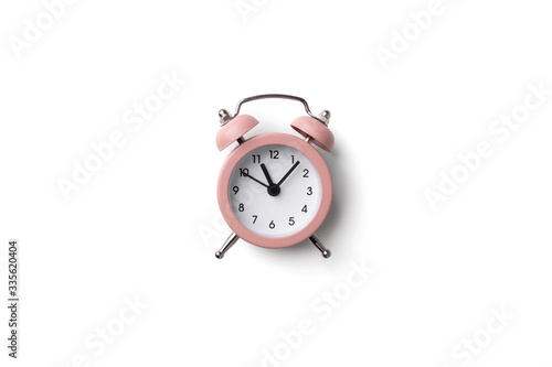 Pink alarm clock isolated on white background with copy space