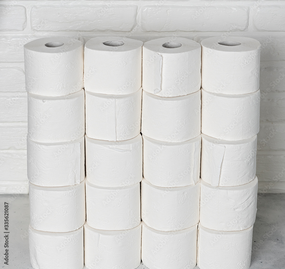 Toilet paper rools stacked on top of each other with brick wall Toilet paper rools stacked on top of each other with brick wall