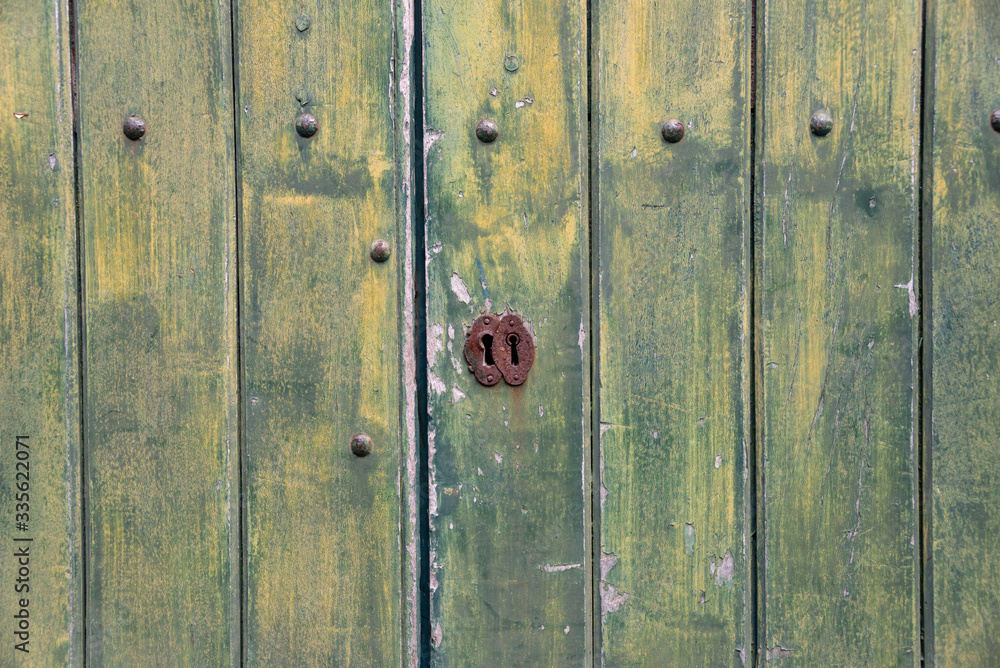 Fototapeta premium Green, wooden, vintage background with keyhole. 