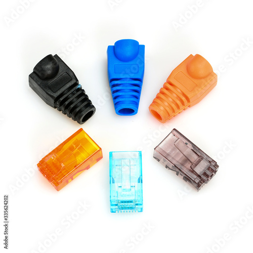 RJ45 connectors and three colored boots for crimping rj-45 plugs for home Internet connection. Home network concept, macro close up isolated on white background.