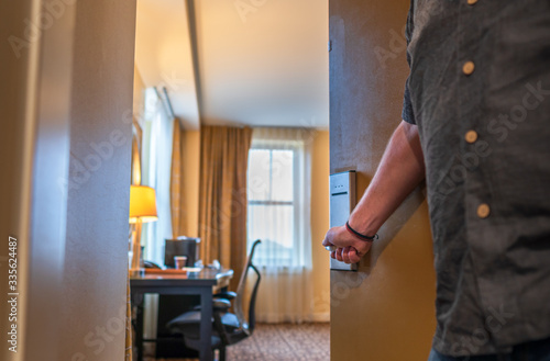 Concept of man opening apartment door and looking into living room with blurred background