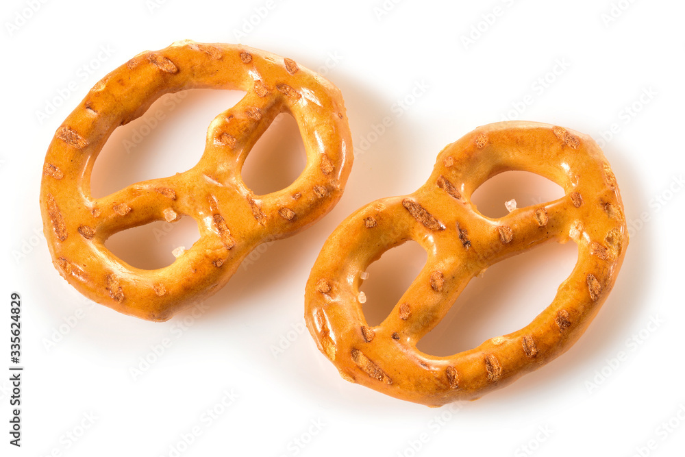 Pretzels, two mini snacks with salt for beer. Savory backed beer snack. Macro close-up isolated on white background with shadow Pretzels, two mini snacks with salt for beer. Savory backed beer snack. Macro close-up isolated on white background with shadow