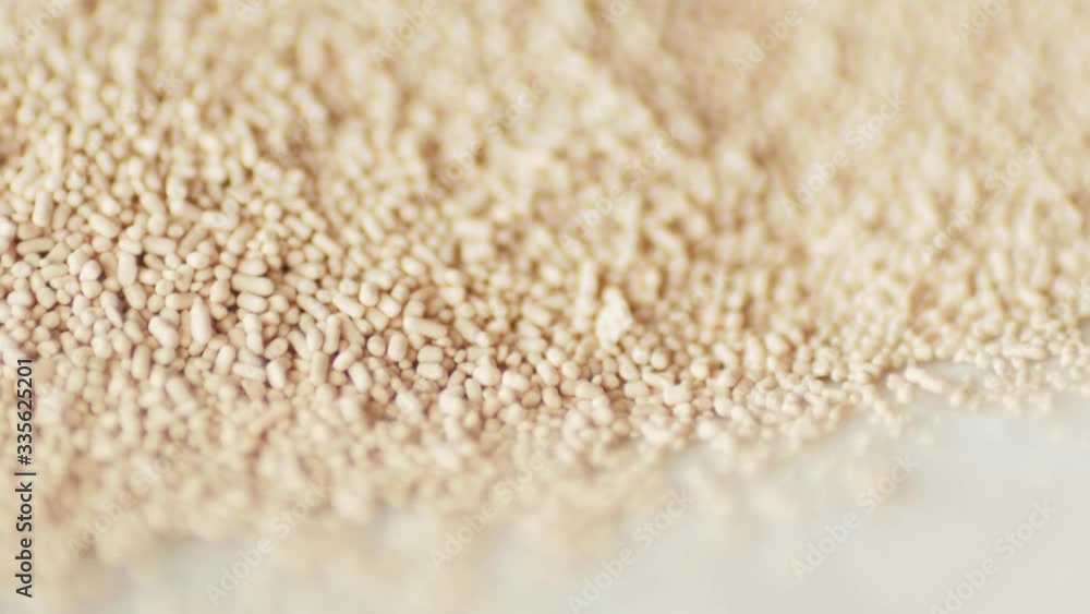 dry instant yeast rotating turning round on white plate extreme macro dry instant yeast rotating turning round on white plate extreme macro