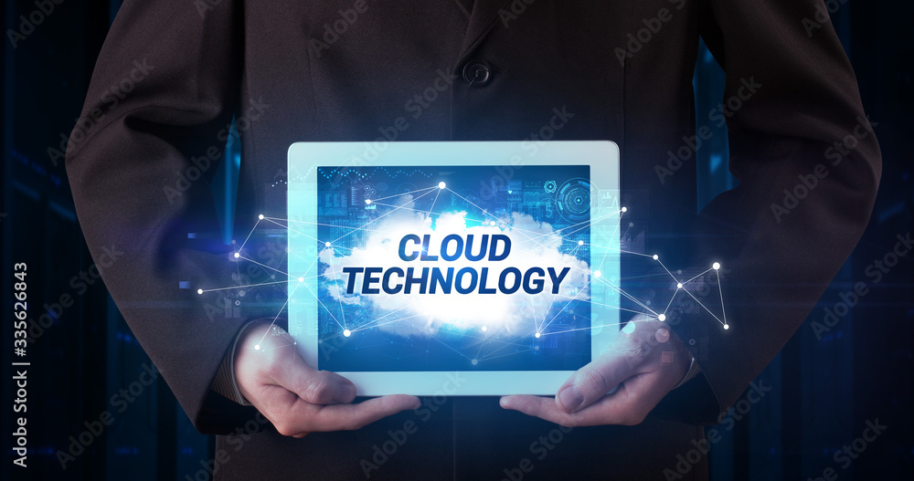 Young business person working on tablet and shows the inscription: CLOUD TECHNOLOGY Young business person working on tablet and shows the inscription: CLOUD TECHNOLOGY