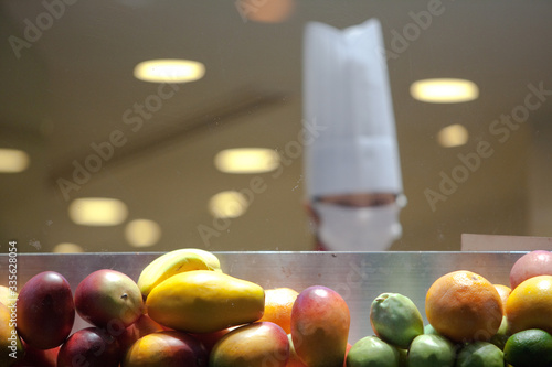 Fruit being prepared by Japanese cook with facemark innTokyo restaurant photo