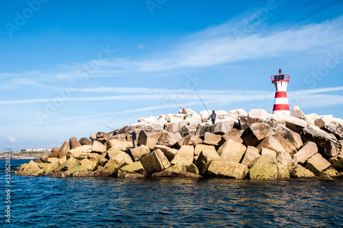 lighthouse among an omntaña of stones in the middle of the sea and in solitude and absolute calm and peace