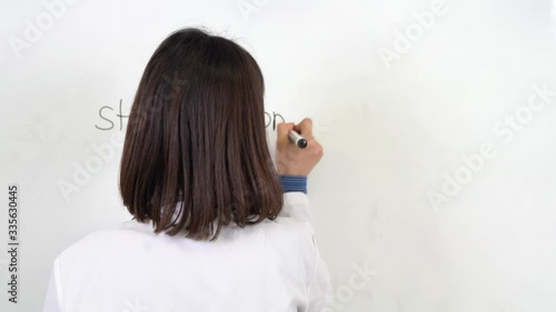 Wallpaper Mural A woman doctor is warning people to stay at home because of coronavirus outbreak. Writing Stay at home on board and showing positive covid-19 test tube. Torontodigital.ca