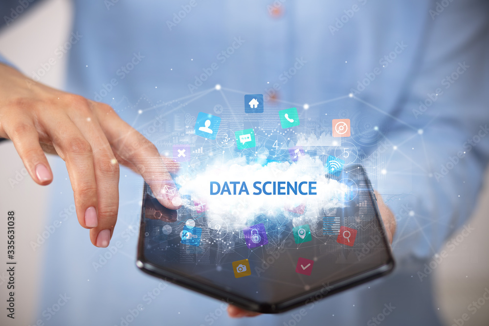 Businessman holding a foldable smartphone with DATA SCIENCE inscription, technology concept Businessman holding a foldable smartphone with DATA SCIENCE inscription, technology concept