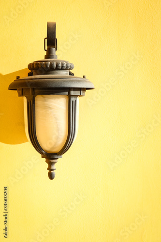 A Lamp with shadow on a wall background.