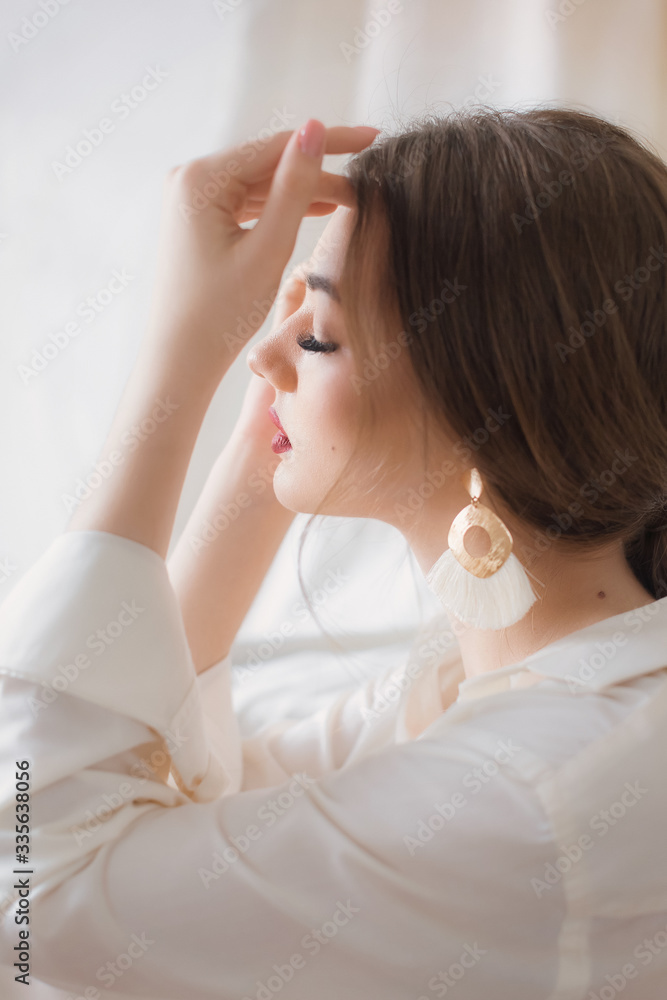Portrait of beautiful young woman with makeup in fashion white clothes Portrait of beautiful young woman with makeup in fashion white clothes