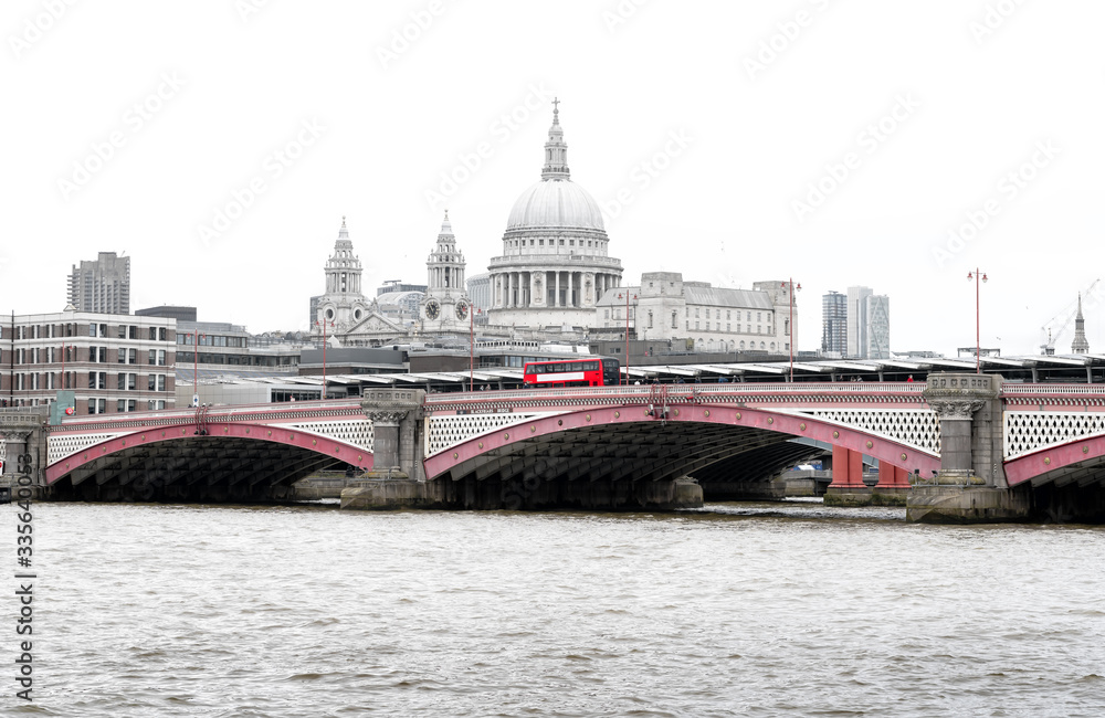 Red British Bus on Blackfriars Bridge with St Paul's Cathedral and London Skyline, UK