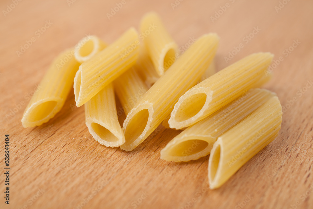 Penne rift macro paste on wooden background Penne rift macro paste on wooden background