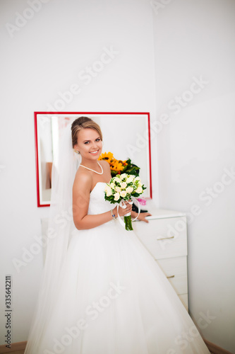 morning bride in her home, blonde in white dress