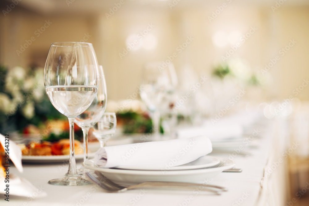 closeup of empty wineglasses on serving table with dishes. weddi closeup of empty wineglasses on serving table with dishes. weddi