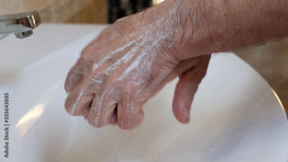 Senior man washing hands to protect from corona virus, covid 19. Close up Senior man washing hands to protect from corona virus, covid 19. Close up