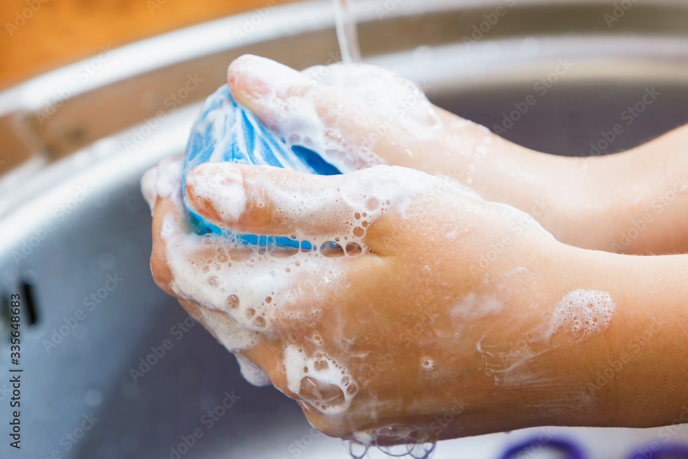 Fototapeta premium Water flows on children's hands