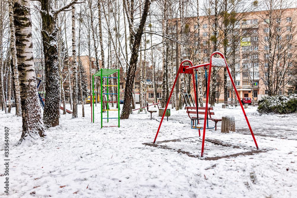Old soviet apartment flat buildings and playground in Rivne, Ukraine in winter cold snow weather gray gloomy poverty architecture Old soviet apartment flat buildings and playground in Rivne, Ukraine in winter cold snow weather gray gloomy poverty architecture