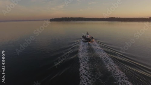 Ferryboat Crossing to the Mainland At Dawn. Aerial view of a small 21 car ferry makes the morning sailing from Lummi Island to Gooseberry Point on the Lummi Indian Reservation. 
