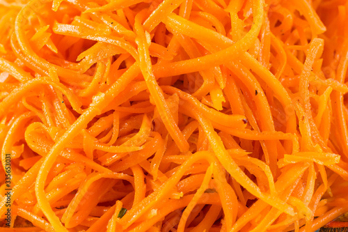 carrot salad with pine nuts and olives isolated on white background