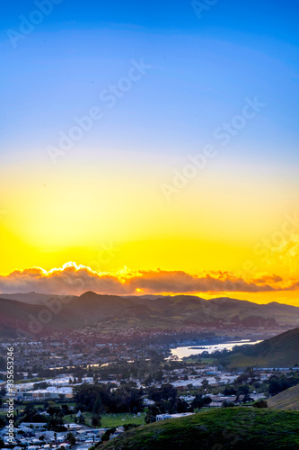 Sunset over mountains and lake and city
