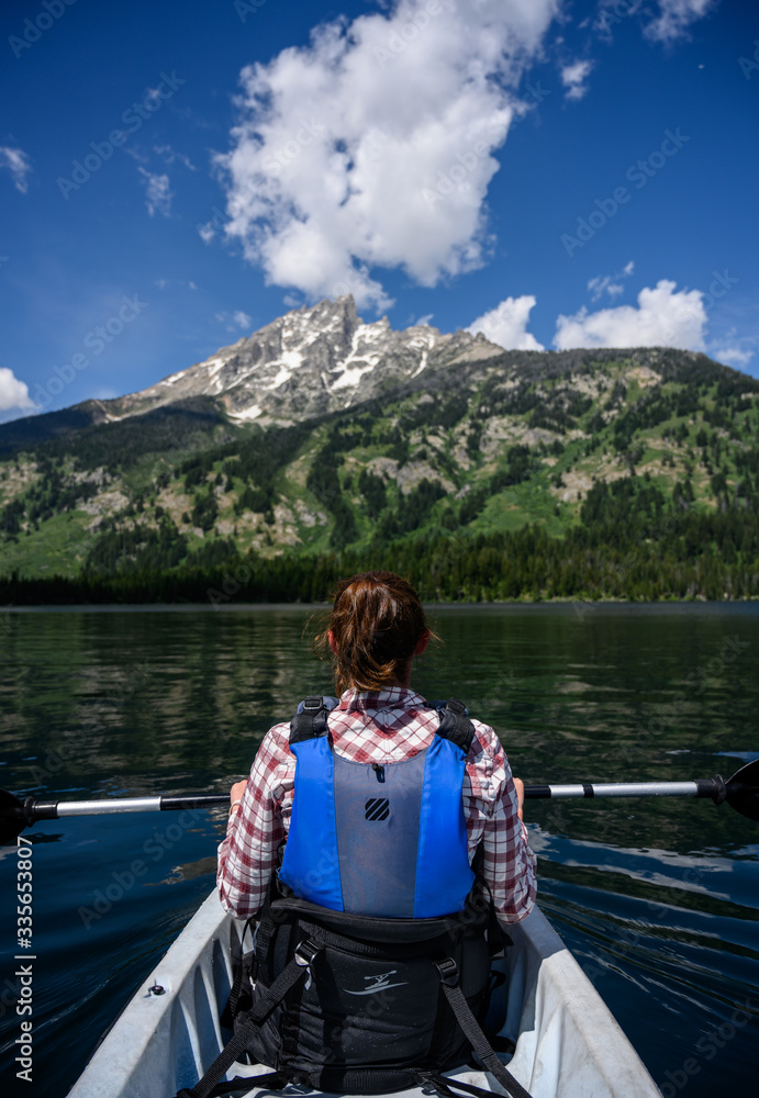 Woman Kayaks in Summer Below Tetons