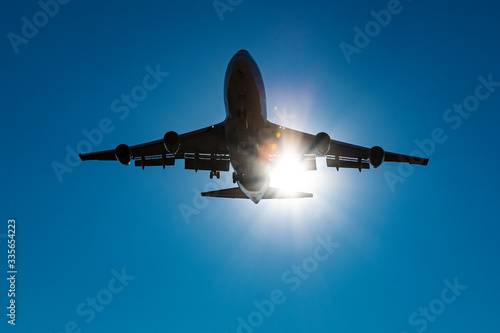 Shape of a Boeing 747 with a sun light leak under a blue sky.