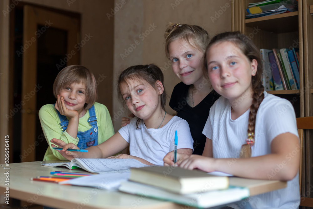 Fototapeta premium Girlfriends learning lessons at home at desk.