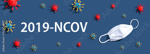 2019-NCOV theme with virus and a white mask - flat lay