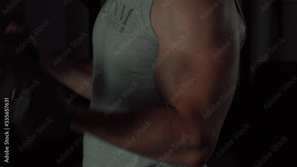 muscular guy lifts a dumbbell muscular guy lifts a dumbbell