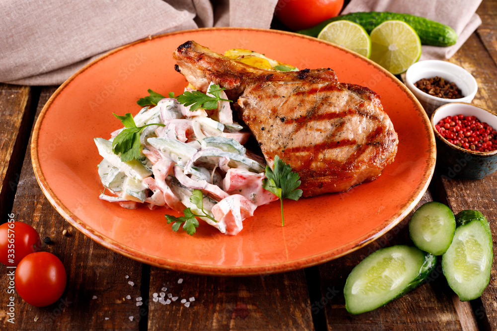 Roast pork loin served with vegetables in sauce Roast pork loin served with vegetables in sauce