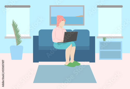 A woman works at home at a computer.