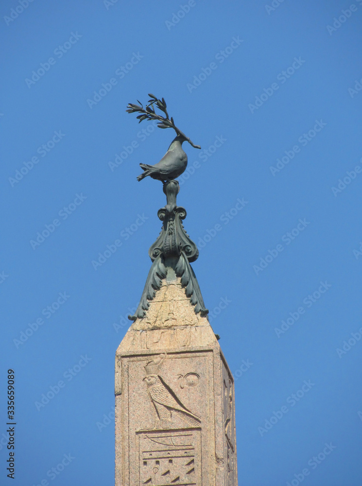 The dove with an olive branch on top of the obelisk, set on the Piazza Navona in Central Rome. Italy, Rome, August, 2012
