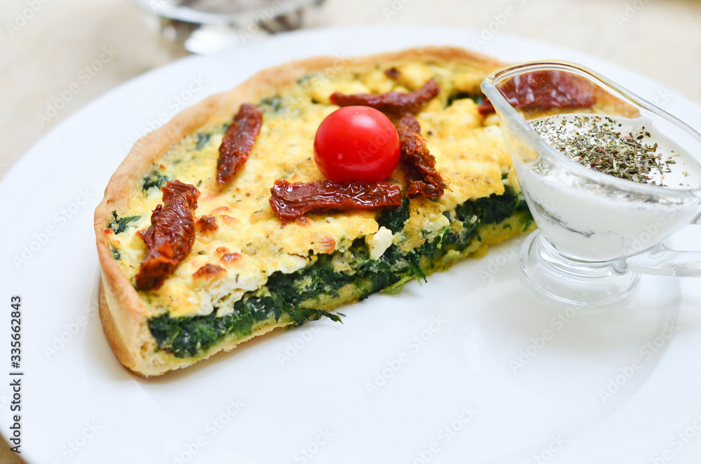 quiche with spinach with herbs and sluggish tomatoes and a creamy sauce quiche with spinach with herbs and sluggish tomatoes and a creamy sauce