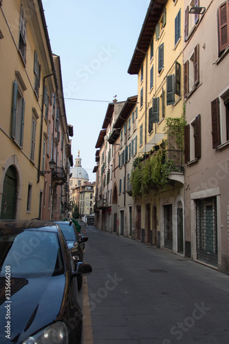Narrow street with Saint Mary of the Peace Church on background, Brescia Old Town, Lombardy, Italy. © daisy_y