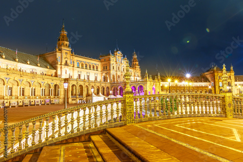 Central Renaissance building of Spain Square seen from Leon Bridge in Seville. Night view of Plaza de Espana, a popular tourist attraction and landmark in Andalusia, Spain. © bennymarty