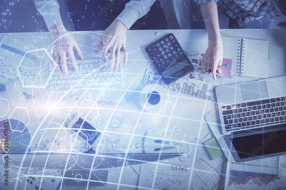 Double exposure of man and woman working together and world map hologram drawing. international network concept. Computer background. Top View. Double exposure of man and woman working together and world map hologram drawing. international network concept. Computer background. Top View.