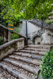 Old stone steps climb up the steep mountain in Grenoble France