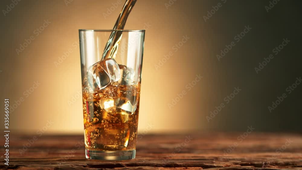 Super Slow Motion Shot of Pouring Ice Tea into Glass with Ice at 1000fps. Super Slow Motion Shot of Pouring Ice Tea into Glass with Ice at 1000fps.