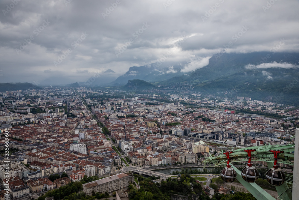 Looking down on Grenoble France with the Téléphérique de Grenoble Bastille bubbles in the lower right corner