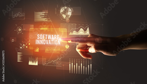 Hand touching SOFTWARE INNOVATION inscription, new business technology concept