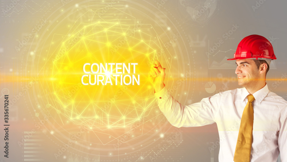 Handsome businessman with helmet drawing CONTENT CURATION inscription, social construction concept Handsome businessman with helmet drawing CONTENT CURATION inscription, social construction concept