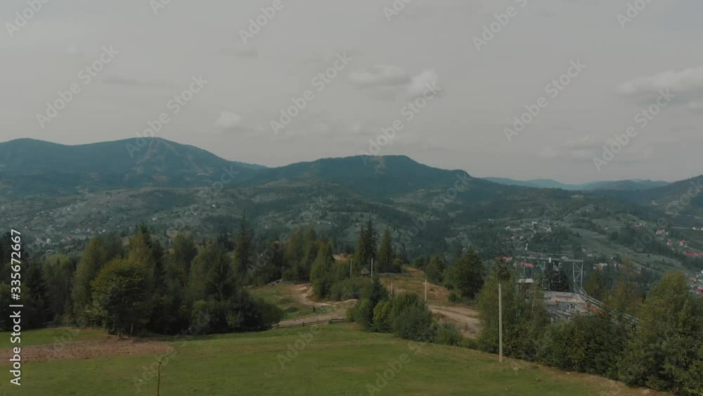 Aerial view of beautiful spring mountains and sensual couple of groom and bride in white wedding dress on a hill. Scenic landscape. Aerial view of beautiful spring mountains and sensual couple of groom and bride in white wedding dress on a hill. Scenic landscape.