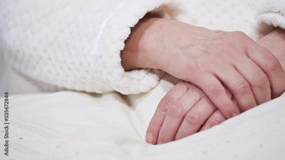 Close up of Hands of an old woman folded one over the other. Elderly woman with folded hands . Close up of Hands of an old woman folded one over the other. Elderly woman with folded hands .