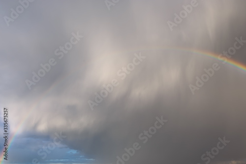 Thundercloud and rainbow over the city © kpn1968