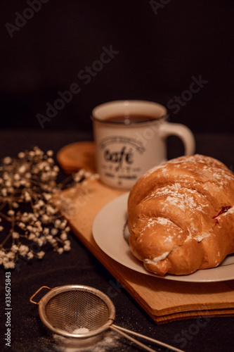  strawberry croissant with a cup of coffee