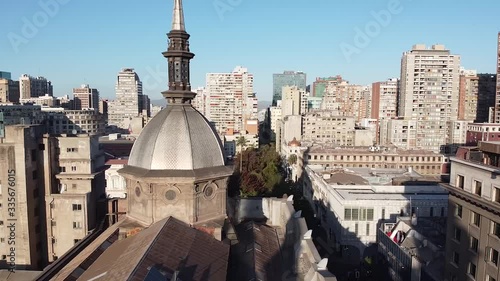 Aerial view of Santiago city skyline and drone fly over Santiago Metropolitan Cathedral roof and near back dome. Santiago, Chile.