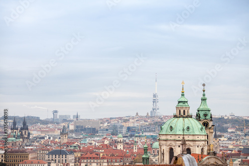 Panorama of Prague, Czech Republic, seen from above, during an autumn cloudy afternoon. Major tourist landmarks such as Zizkov TV Tower and Kostel Svateho Mikulase church and cathedrals are visible