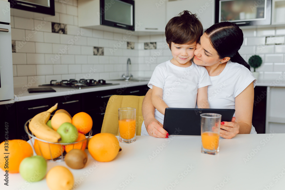 Happy family using a tablet pc in kitchen