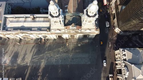 Aerial view from drone of square opposite of Santiago Metropolitan Cathedral entrance. Bird's eye view from above of catholic church domes and walking people. Plaza de Armas, Santiago, Chile