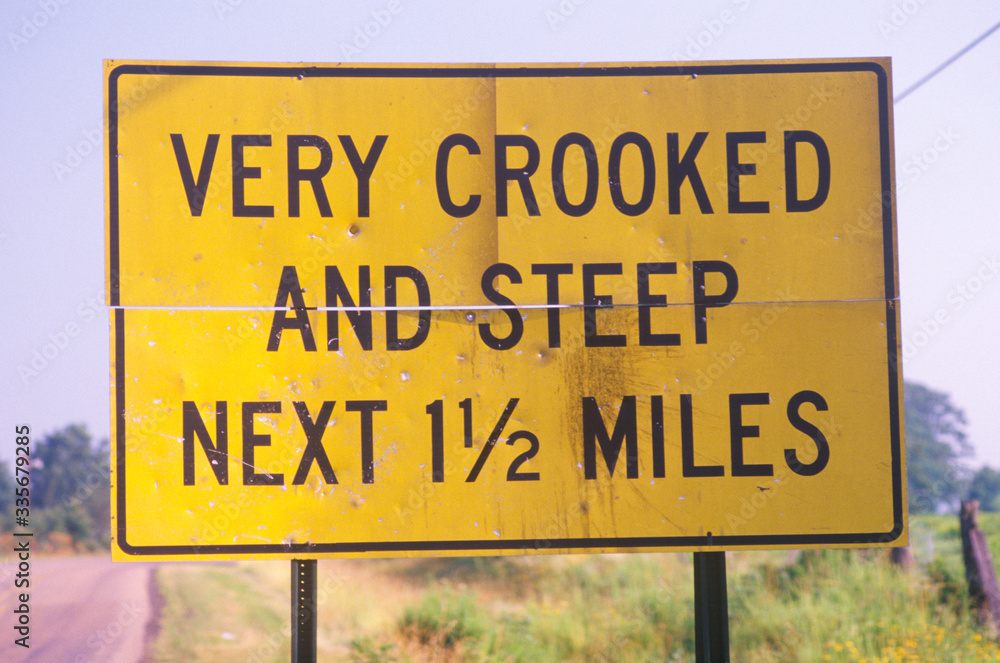 A sign that reads ÒVery crooked and steep next 1 1/2 milesÓ